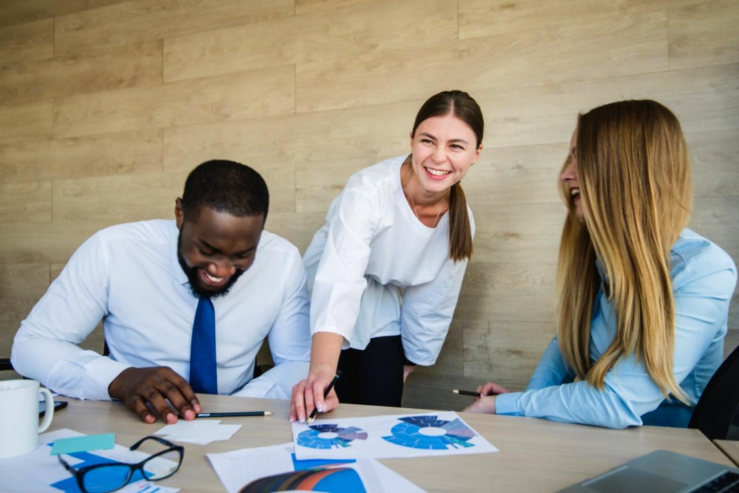 Finance team analyzing digital reports and performance metrics